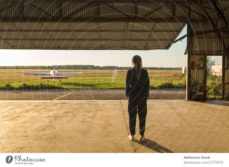Woman posing inside of hangar Hangar Posture Aviation occupation Vacation & Travel Cheerful Freedom Transport Youth (Young adults) Adventure Landscape