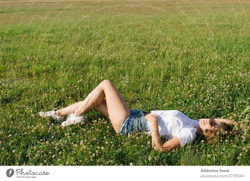 Confident girl posing in green field Woman Field Lie (Untruth) Cheerful Posture Happiness Easygoing Freedom Nature Summer Landscape Meadow romantic Fresh Dream