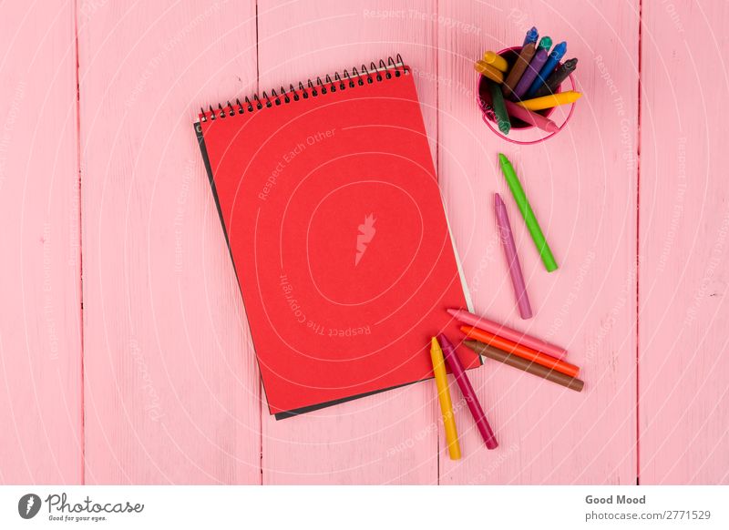 Blank red note pad and crayons on pink wooden table Design Desk Table School Office Business Infancy Art Tie Paper Pen Wood Draw Above Pink Red Colour Crayon
