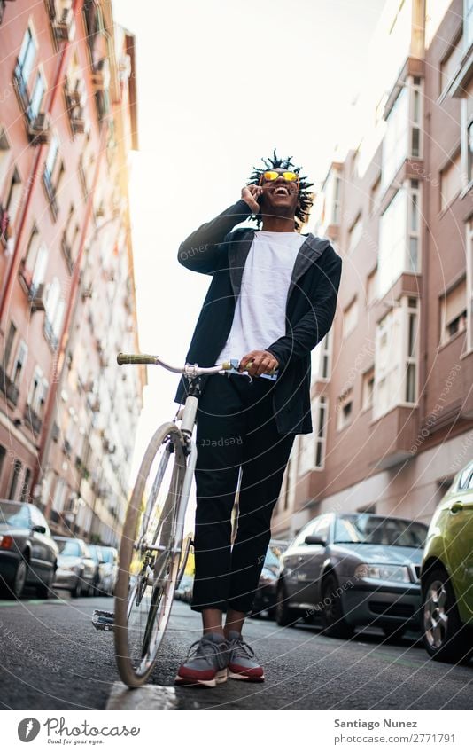 Handsome young man using mobile phone and fixed gear bicycle. Man Youth (Young adults) African Black mulatto Afro Mobile Bicycle fixie Telephone Lifestyle Stand