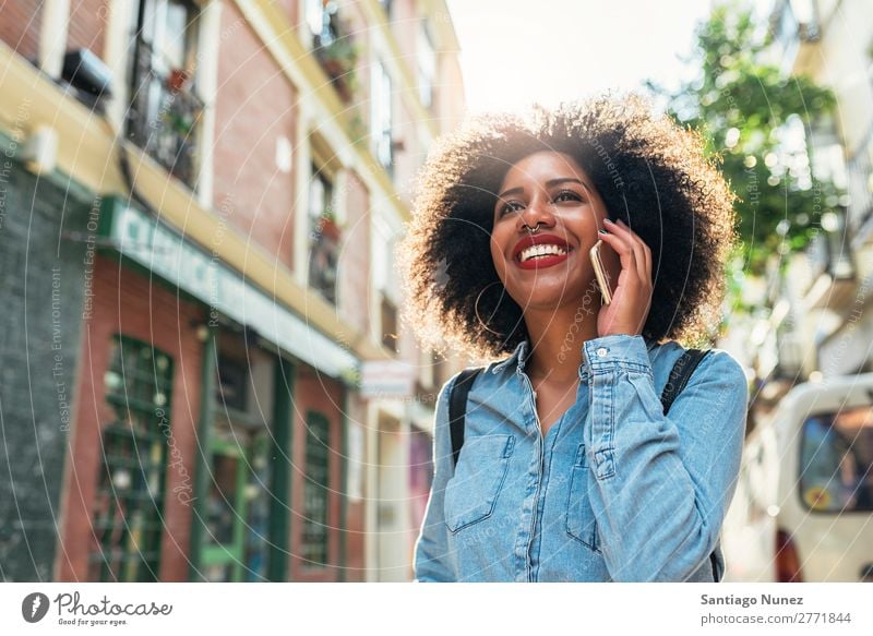 Beautiful afro american woman using mobile in the street. Woman Black African Afro Human being Portrait photograph PDA Youth (Young adults) Mobile Telephone