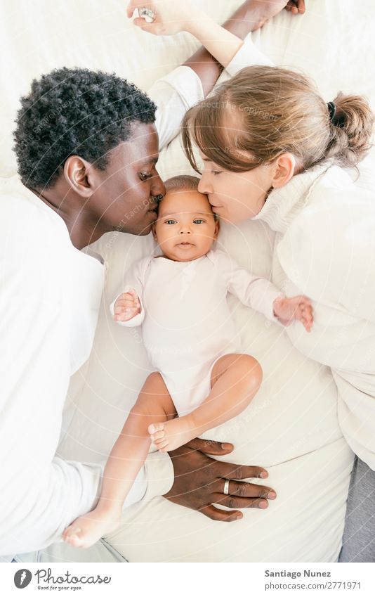 Happy Family, Mother, Father And Baby. Boy (child) Child Bed Girl Lie (Untruth) Newborn Parents multiethnic African diverse Love Kissing Human being interracial