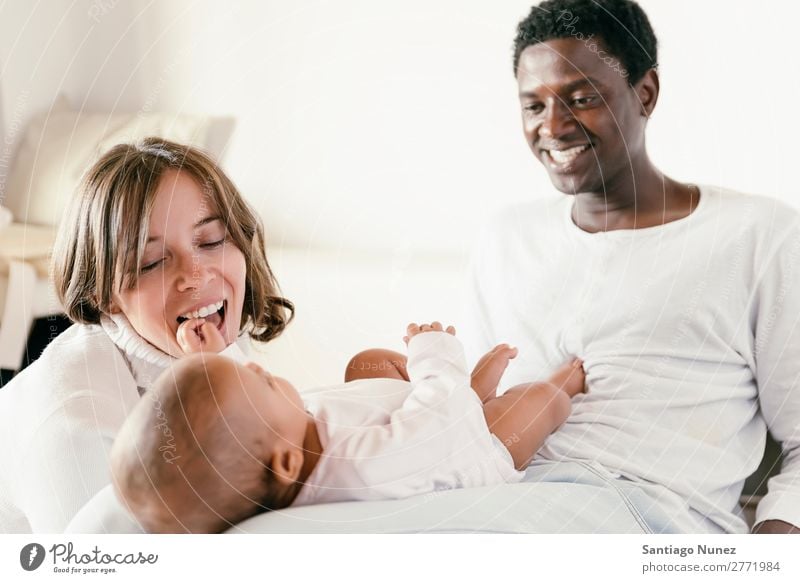 Happy Family, Mother, Father And Baby. Boy (child) Child Bed Girl Lie (Untruth) Newborn Parents multiethnic African diverse Human being interracial Caucasian