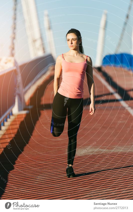 Young fitnesswoman runner stretching legs after run. Running Runner Action Athlete Athletic Railroad Fitness Woman workout Practice Sports Stretching Cellphone