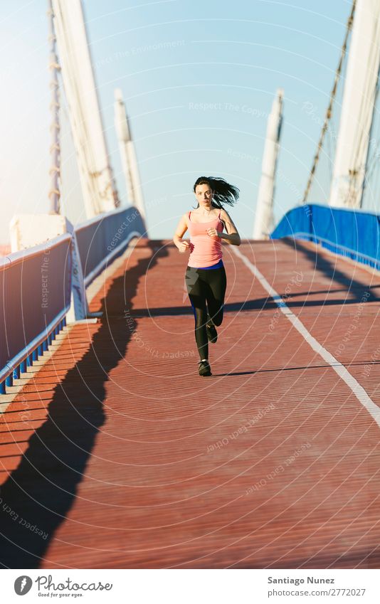 Young fitness woman runner running on city bridge. Running Runner Action Athlete Athletic Railroad Fitness Woman workout Practice Sports Strong Body Effort