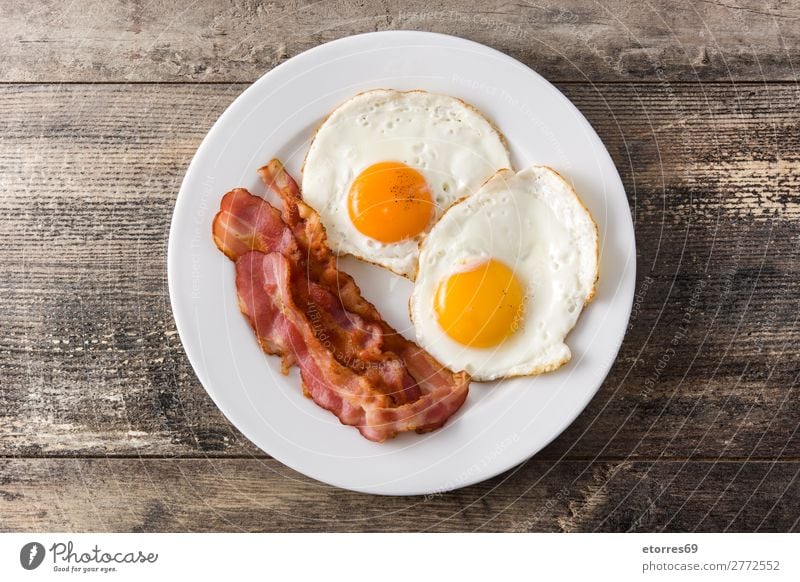 Fried eggs and bacon for breakfast on wood Egg Bacon Frying Breakfast Fried egg sunny-side up Plate Food Healthy Eating Food photograph isolated English British
