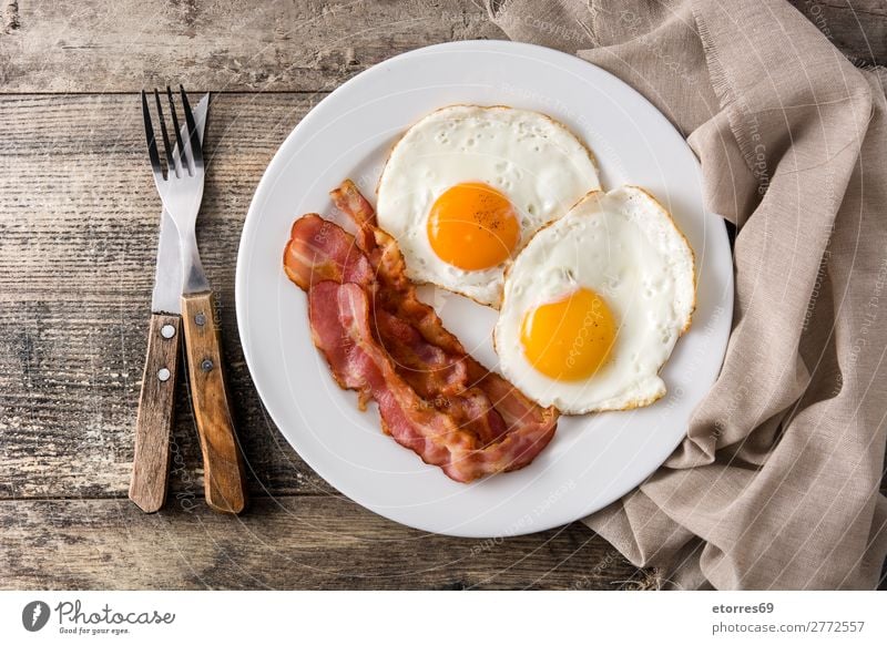 Fried eggs and bacon for breakfast on wood Egg Bacon Frying Breakfast Fried egg sunny-side up Plate Food Healthy Eating Food photograph isolated English British