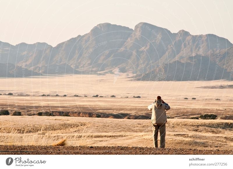 Watch what runs Human being Masculine 1 Environment Nature Landscape Rock Mountain Peak Desert Looking Stand Take a photo Man Loneliness Far-off places Steppe