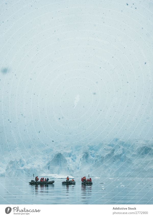 People sailing on ice lake Human being Sailing Snowfall Lake glacial tourists Haze Ice Tourism Watercraft Frost Transparent Landscape North Weather Extreme