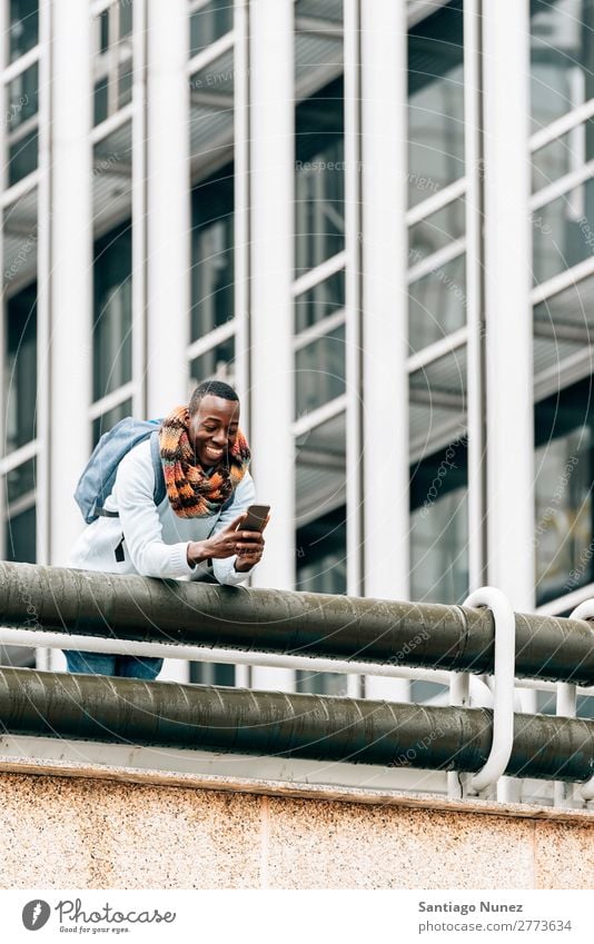Businessman in the Street. Man Black African American Cellphone Youth (Young adults) Telephone Happy Mobile Exterior shot PDA texting Communication Typing