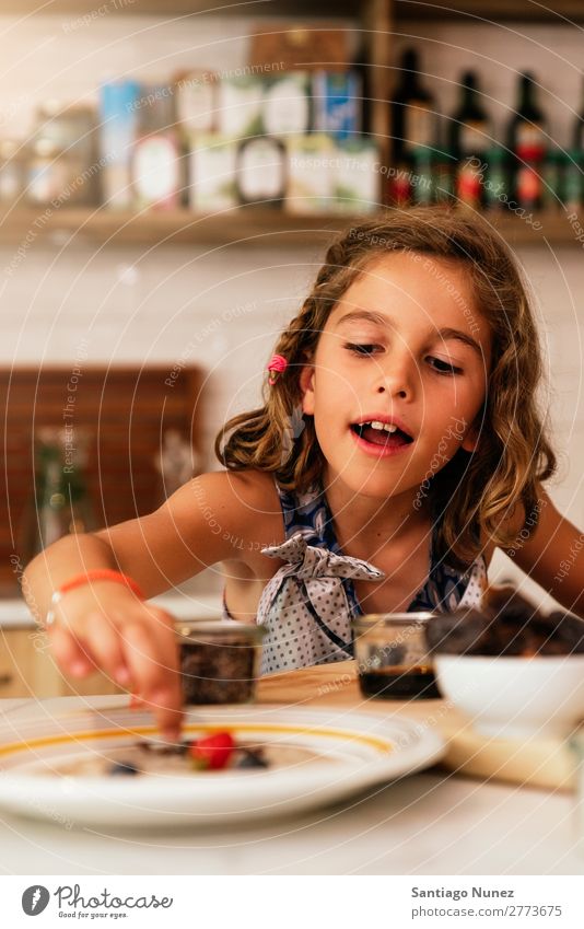 Portrait of little girl preparing baking cookies. Girl Child Nutrition Portrait photograph Cooking Kitchen Appetite Preparation Make Smiling Laughter Lunch Baby