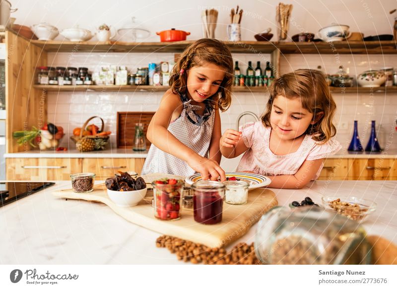 Little sisters girl preparing baking cookies. Child Girl Cooking Kitchen Chocolate Ice cream Strawberry Daughter Day Happy Joy Family & Relations Love