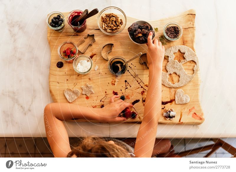 Top view of little girl preparing baking cookies. Girl Child Nutrition Portrait photograph Cooking Kitchen Appetite Preparation Make Lunch Baby Dirty stained