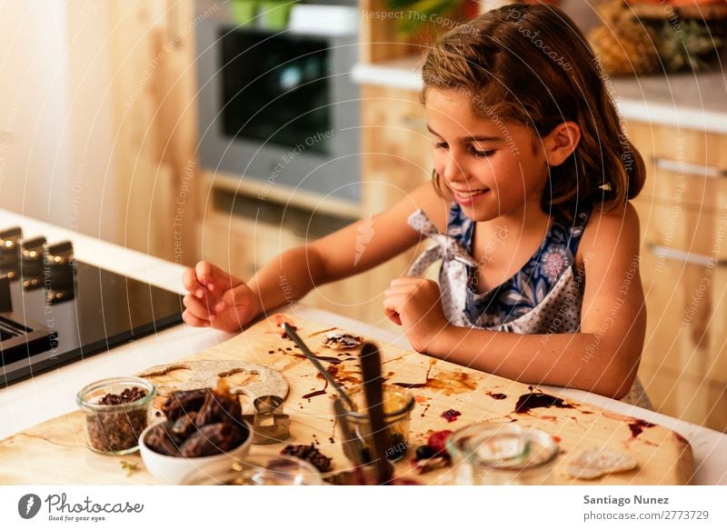 Portrait of little girl preparing baking cookies. Girl Child Nutrition Portrait photograph Cooking Kitchen Appetite Preparation Make Smiling Laughter Lunch Baby