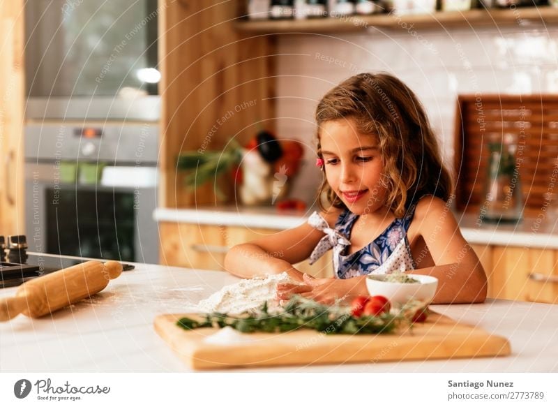 Portrait of little girl preparing baking cookies. Girl Child Nutrition Portrait photograph Cooking Kitchen Bakery Baking Appetite Preparation Make Smiling