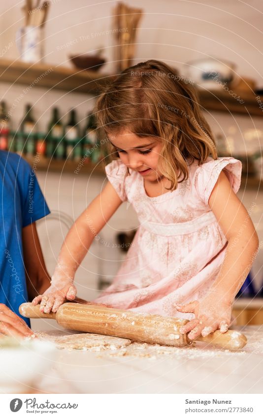 Little child girl kneading dough prepare for baking cookies. Child Girl Cooking Kitchen Flour Chocolate Daughter Day Dough Happy Joy Family & Relations Love
