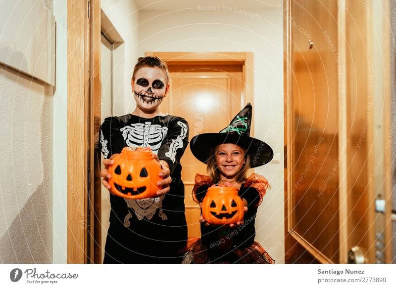 Happy children disguised saying trick or treating. Hallowe'en Child Girl Boy (child) Painting (action, artwork) Skeleton Witch Disguised Joy Family & Relations