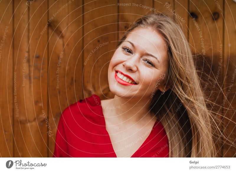 Happy blonde girl with red clothes and lips Lifestyle Beautiful Hair and hairstyles Make-up Human being Woman Adults Lips Plant Jacket Blonde Wood Smiling
