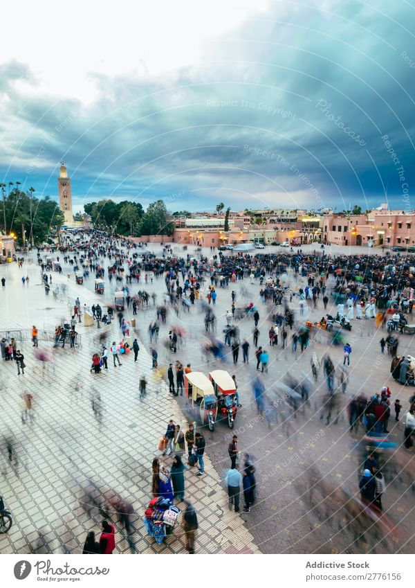 People on square in Marrakech, Morocco Skyline Square crowd Cloud cover in motion Town tourists Architecture City Vantage point Twilight Panorama (Format)