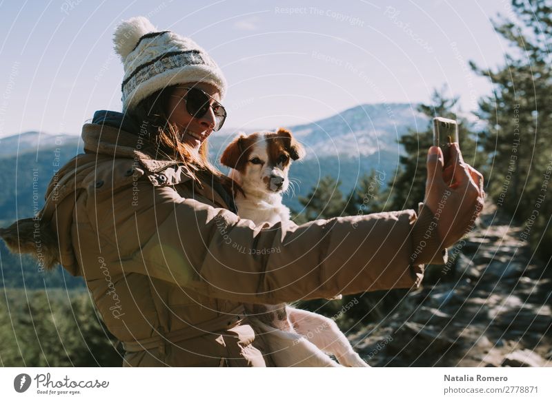 girl makes a selfie with her pet in the mountain Lifestyle Leisure and hobbies Adventure Freedom Snow Mountain Hiking Camera Technology