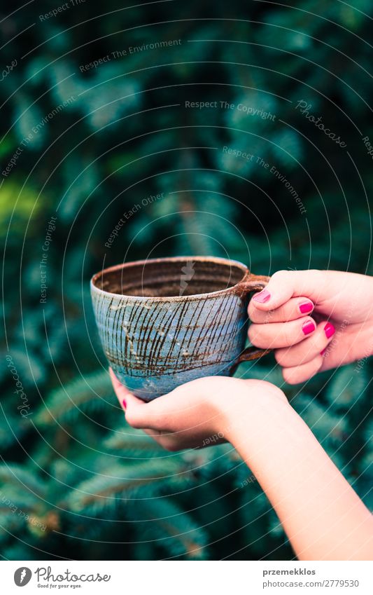 Female hand holding cup with herbal tea Herbs and spices Coffee Tea Pot Lifestyle Design Summer Decoration Table Craft (trade) Hand Art Nature Rain Wood Wet