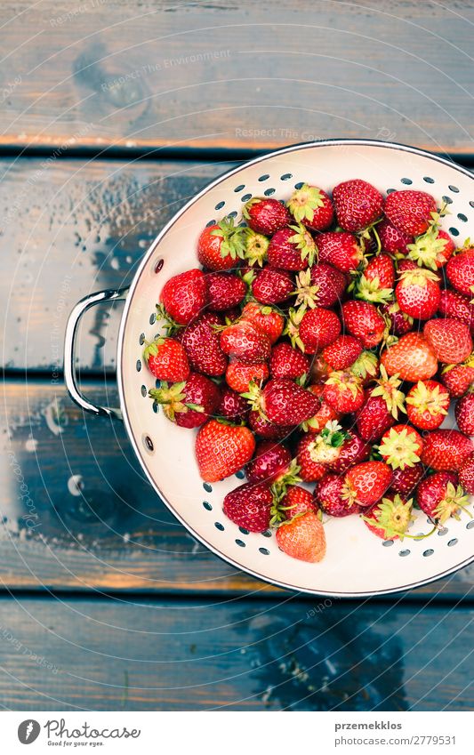 Bowl of fresh strawberries sprinkled raindrops on wooden table Fruit Vegetarian diet Summer Table Nature Wood Fresh Delicious Natural Juicy Red food freshly