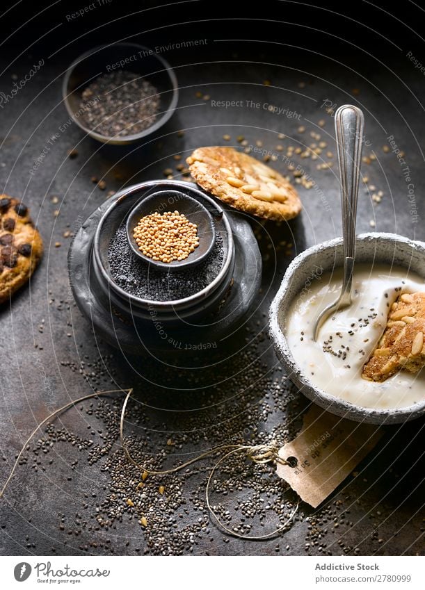 Yogurt with cookies and seed assortment Yoghurt Cookie Seeds Organic Mix chia seeds recipe poppy seeds Gourmet Conceptual design composition Rustic Arrangement