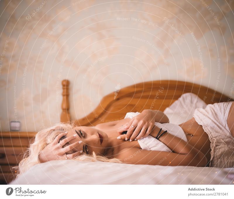 Pretty blonde woman lying on bed with crossed arms Woman beauitful Body Conceptual design third arm Head fancy Fantasy Flower Illusion nobody's Intellect Fairy