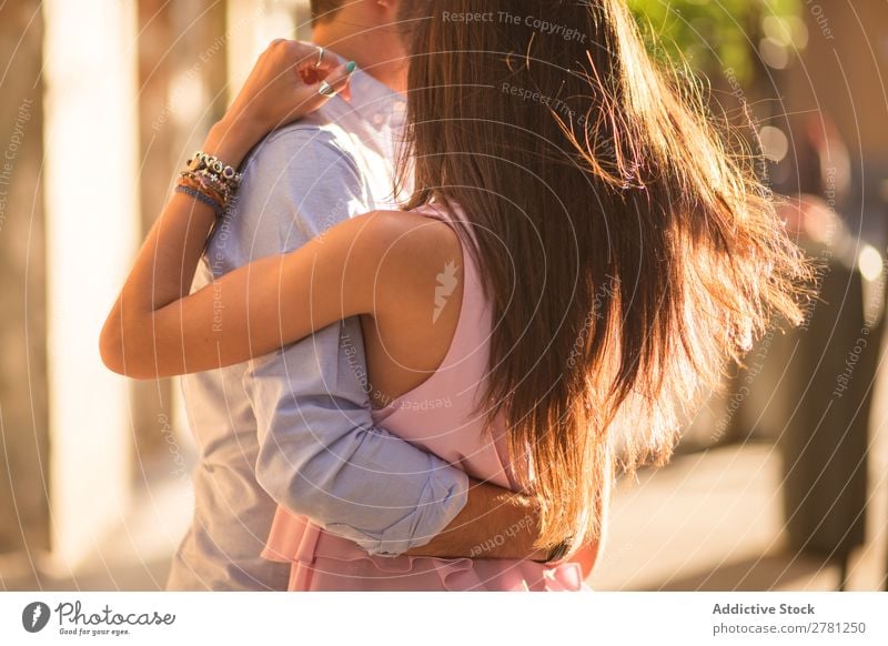 Romantic couple dancing in sunlight Couple Embrace Dance Movement Horizontal flying hair Close-up Crops Unrecognizable Romance Street Rear view Sunlight Bright