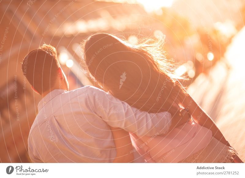 Unrecognizable couple walking embracing together Couple Embrace Street Rear view Sunlight Bright Walking Stern Blur Sunbeam Brunette Horizontal