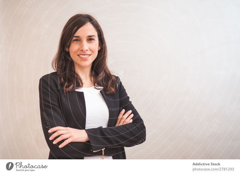 Young smiling woman in suit posing Businesswoman Posture Smiling Gesture Portrait photograph Cheerful Stand Successful Self-confident Positive crossed arms