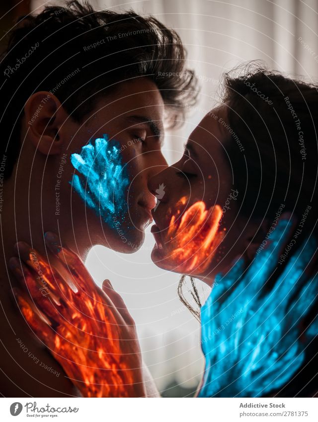 Couple with fluorescent paint kissing Kissing Love Passion Desire Blue Orange Red Colour Painting (action, artwork) Fluorescent Illuminate Art Neon Light