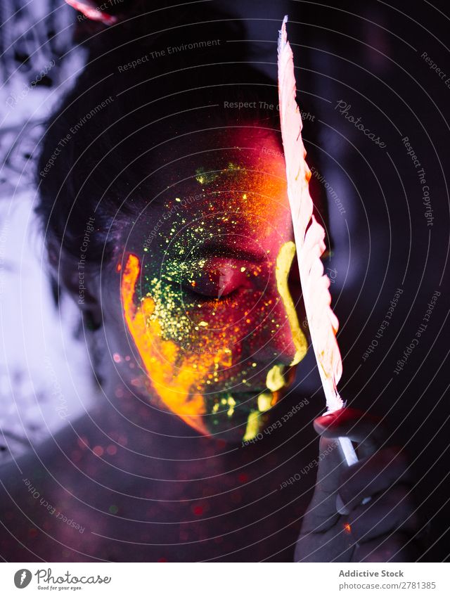 Woman with luminous paint and feather Youth (Young adults) pretty Colour Feather Orange eyes closed Painting (action, artwork) Fluorescent Illuminate Art Neon