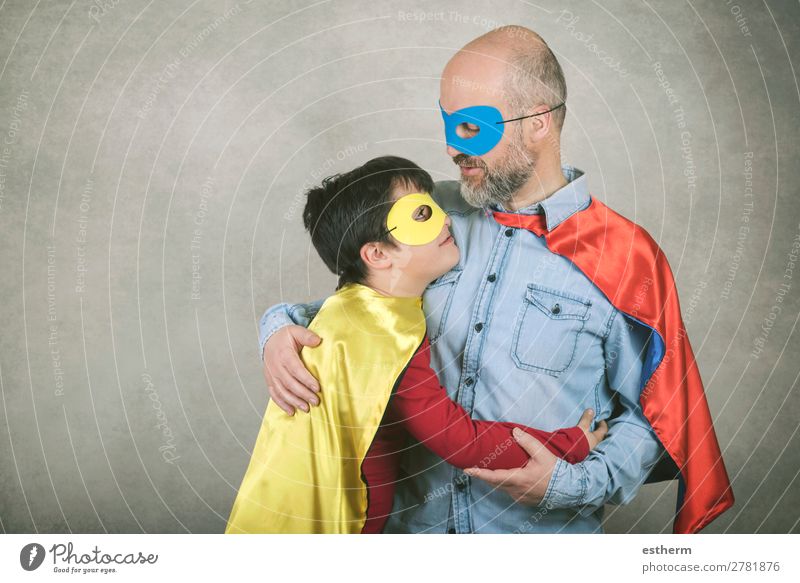 Father's day,father and son dressed as a superhero against gray background Lifestyle Feasts & Celebrations Hallowe'en Fairs & Carnivals Success Human being