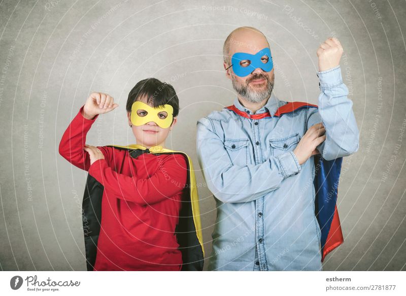 Father's day,father and son dressed as a superhero against gray background Lifestyle Joy Feasts & Celebrations Carnival Hallowe'en Fairs & Carnivals Success