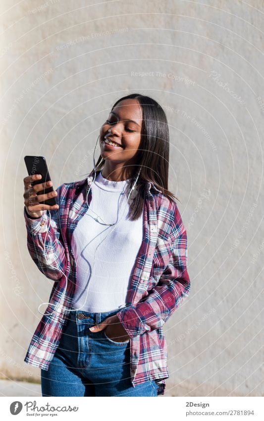 Front view of a young smiling african american woman standing Lifestyle Happy Beautiful Entertainment Music Telephone Human being Feminine Young woman