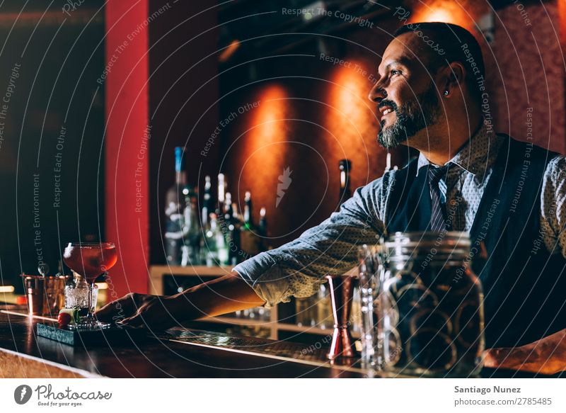 Barman is making cocktail at night club. Cocktail shaker barman bartender Waiter Man Stir mixologist adding Alcoholic drinks Business Service Club Drinking