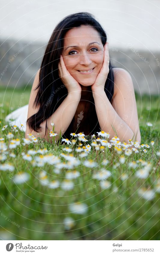 Brunette woman on a flowered meadow Lifestyle Joy Happy Beautiful Face Wellness Relaxation Vacation & Travel Summer Sun Garden Human being Woman Adults Nature