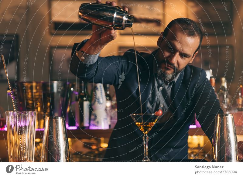 Barman is making cocktail at night club. Cocktail shaker barman bartender Waiter Man Stir mixologist adding Alcoholic drinks Business Club Drinking Professional