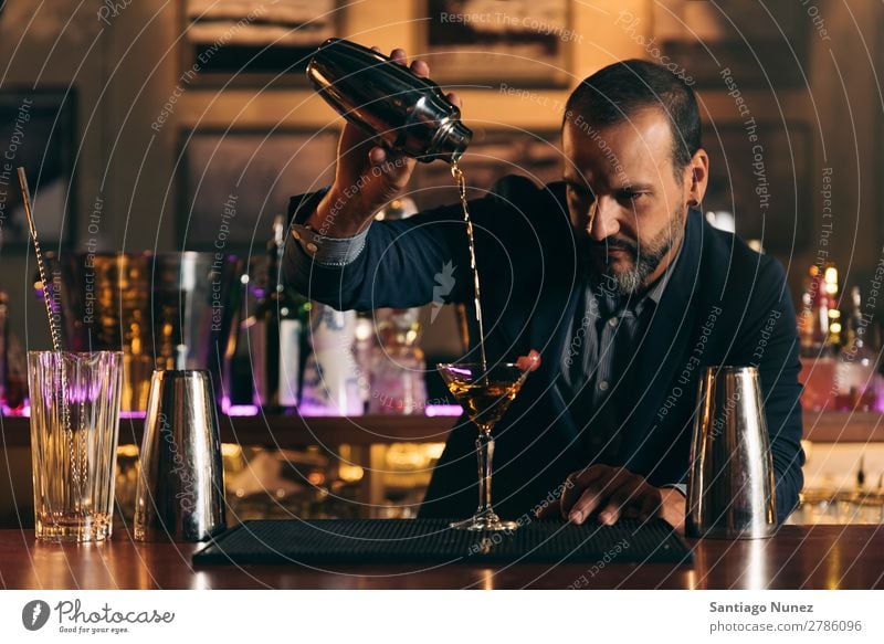 Barman is making cocktail at night club. Cocktail shaker barman bartender Waiter Man Stir mixologist adding Alcoholic drinks Business Club Drinking Professional