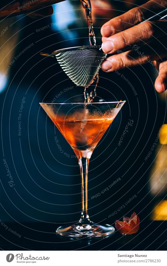 Barman is making cocktail at night club. Cocktail shaker barman bartender Waiter Man Stir mixologist adding Alcoholic drinks Business Club Drinking Bottle