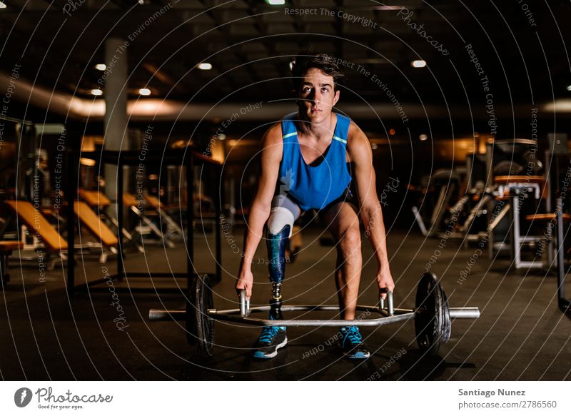 Disabled young man training in the gym. Man Youth (Young adults) Athlete Sports prothestic Handicapped disabled Fitness Action Legs amputate amputation