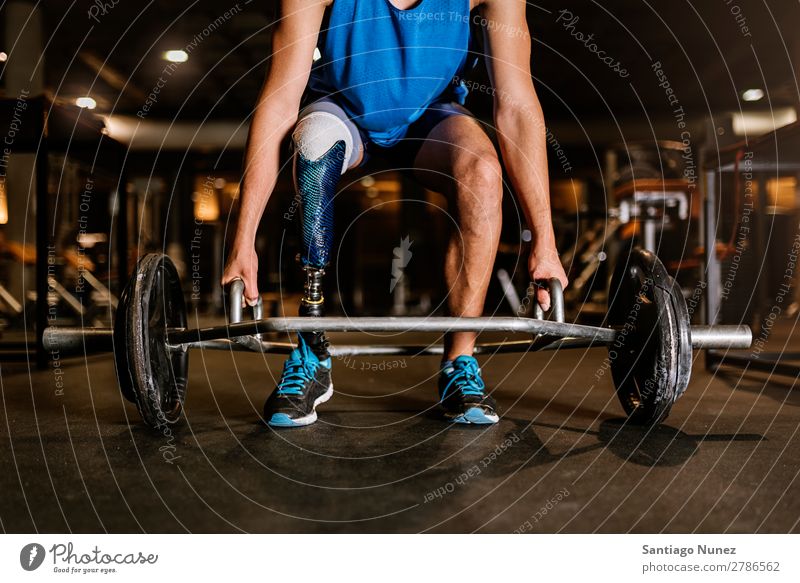 Disabled young man training in the gym. Man Youth (Young adults) Athlete Sports prothestic Handicapped disabled paralympic Fitness Action Legs amputate