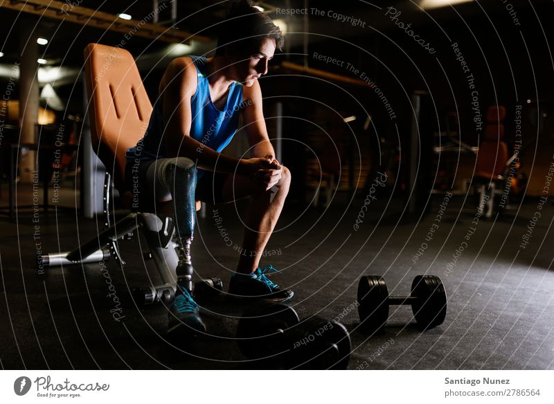 Portrait of disabled young man in the gym. Man Youth (Young adults) Athlete Sports prothestic Portrait photograph Handicapped paralympic Fitness Gymnasium