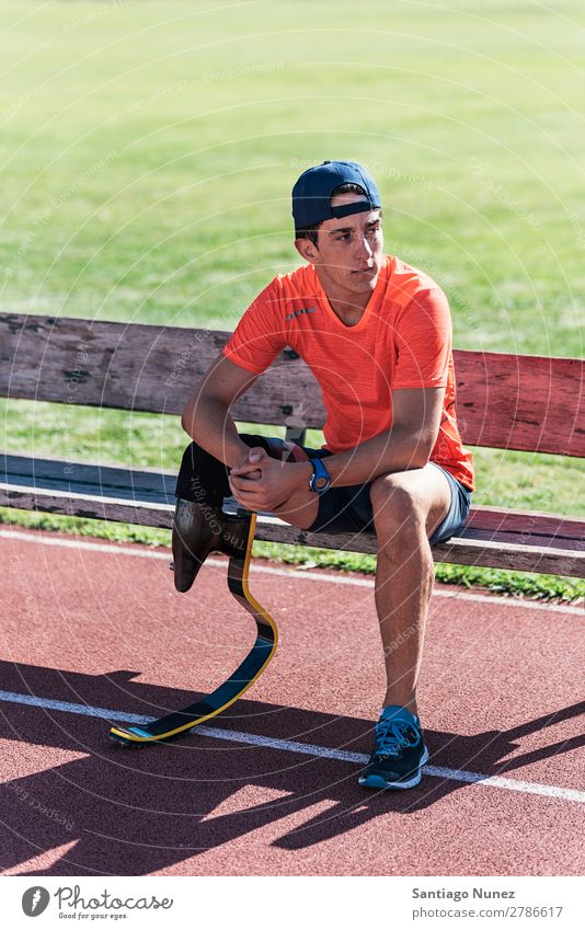 Disabled man athlete taking a break. Man Runner Portrait photograph Athlete Sports prosthesis prosthetic Handicapped disabled paralympic amputation Seat Sit