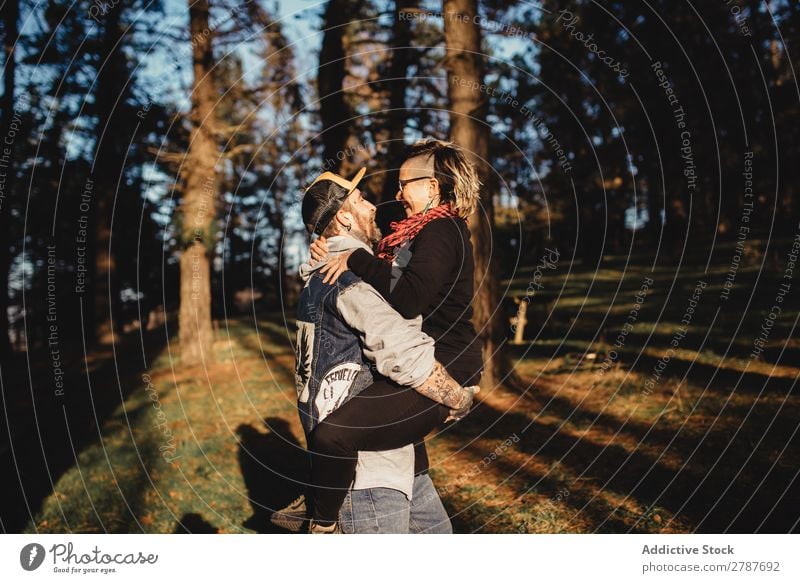 Happy young couple hugging in park Couple Embrace Park Tree Wood Hand Forest Youth (Young adults) Cheerful bearded Man Going Woman Joy embracing Hipster Walking