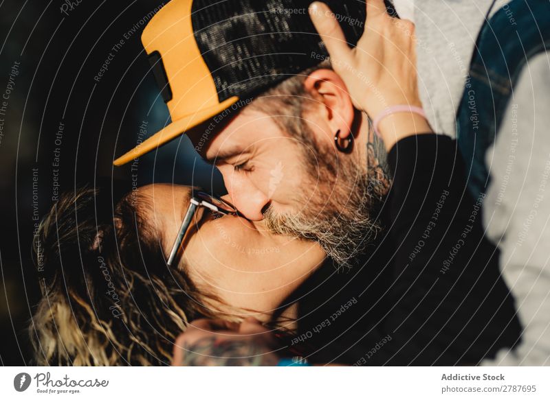 Happy couple hugging and kissing near tree in park Couple Embrace Park Tree embracing Back Wood Forest Youth (Young adults) Cheerful bearded Man Woman Joy