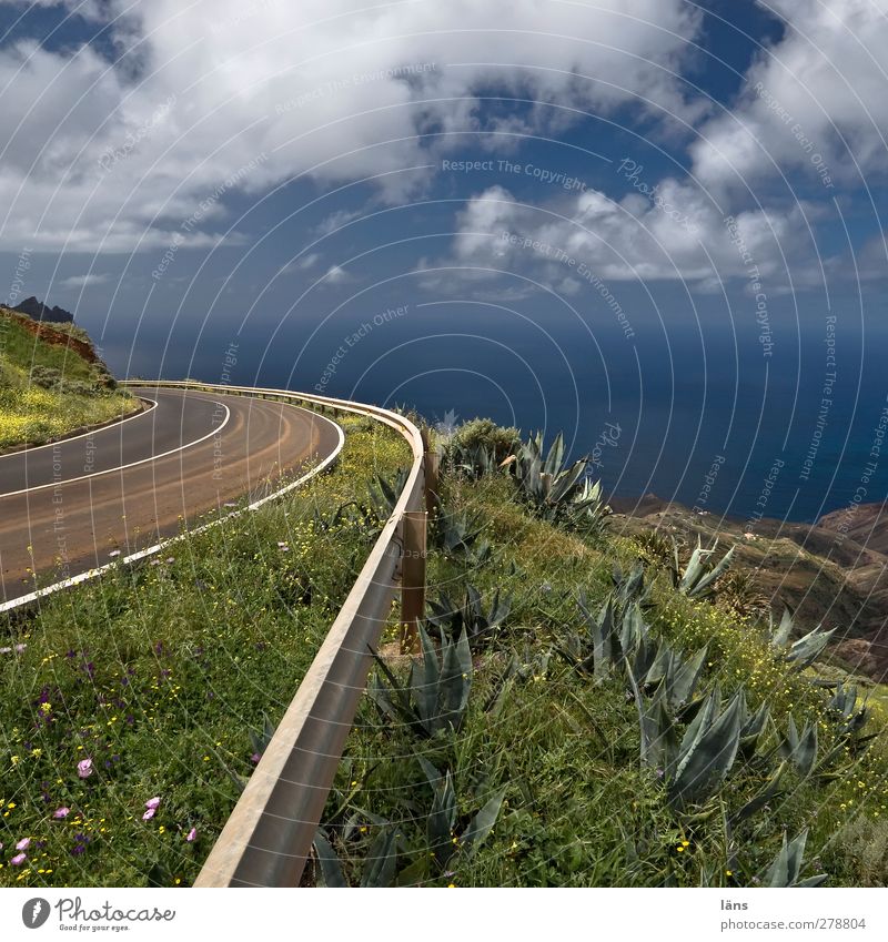 to the sea Ocean Landscape Sky Clouds Wild plant Hill Mountain Coast Traffic infrastructure Street Overpass Blue Green Crash barrier Signs and labeling