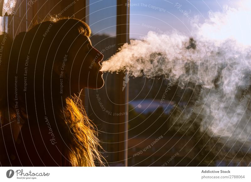 Young woman smoking near window Woman Smoking Window Flat Closed eyes Youth (Young adults) Night Lady Evening Home House (Residential Structure) Smoke Unhealthy