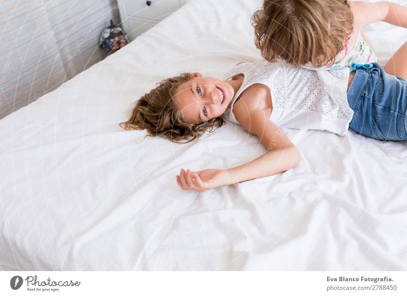 Two beautiful sisters playing on bed Lifestyle Joy Beautiful Leisure and hobbies Playing Summer House (Residential Structure) Bed Bedroom Child Human being